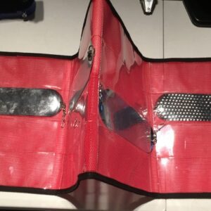 A red wallet with some metal plates on it