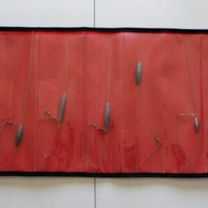 A red cloth with black trim and some leaves on it